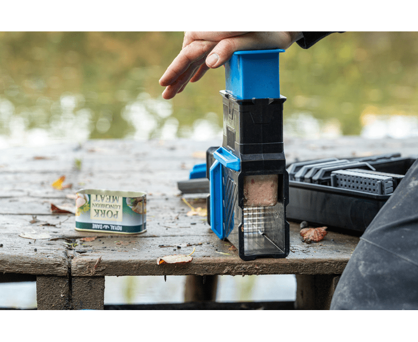 fish scaler, manual tool, blue black, on table, can labeled